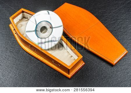 Mini Compact Disc Or Pocket Compact Disc In Coffin.concept.