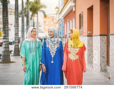 Happy Muslim Women Walking In The City Center - Arabian Teen Girls Having Fun Spending Time Together