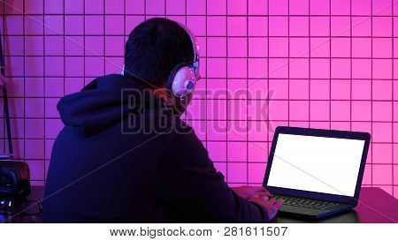 Man In Headphone Playing Video Game At Home. White Display.