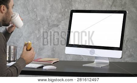 Busy Businessman Having Late Lunch Eating Sandwich In Office Working. White Display.
