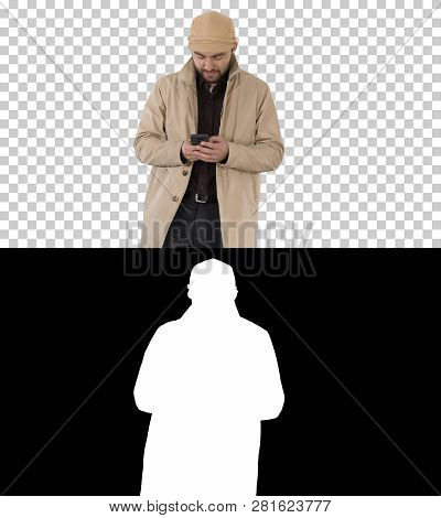 Young Handsome Man In Cloak Messaging With Phone, Alpha Channel