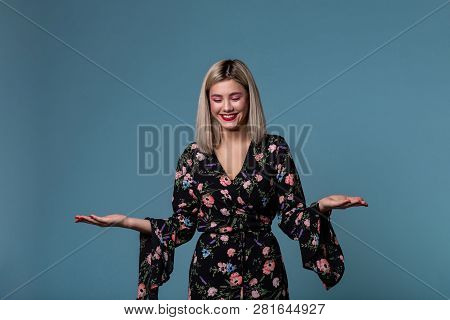 Blonde Young Woman In Spring Dress Showing Open Palm With Copy Space For Prodact