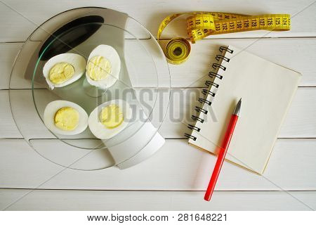 Counting The Amount Of Protein, Fat, Carbohydrates And Calories In Food. Chicken Egg On The Kitchen 