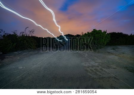Light Trails Of Couple Walik Or Trekking Past On Top Mount Maunganui On Dark Night