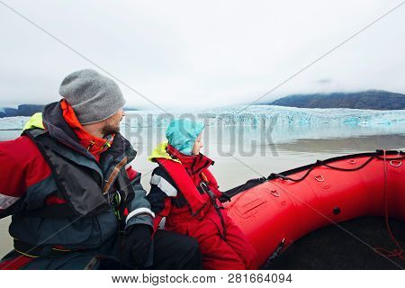 Family Of Two, Positive Little Boy And His Father, In The Boat Enjoying Together The View Of Fjallsa