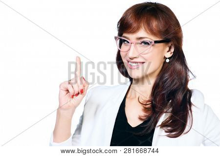 A close up portrait of a beautiful woman wearing classic clothes and posing over the white background in the studio. Beauty, fashion, business.