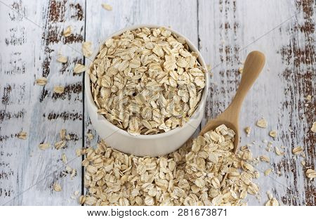 Dried Oats Or Oatmeal In A Bowl On The Wood Table. Its Are A Nutrient-rich Food Associated With Prot