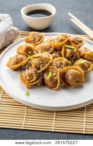 Home Made Chinese And Korean Dumplings Served On The Traditional Steamer And Bamboo Mat Decorated Wi