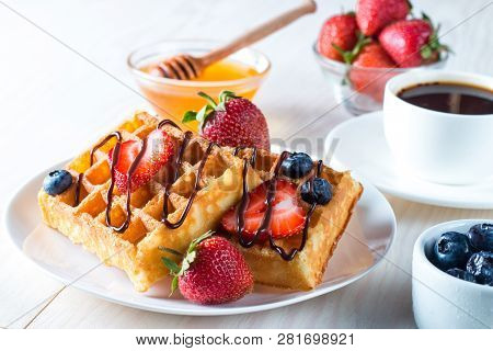 Fresh Homemade Food Of Berry Belgian Waffles With Honey, Chocolate, Strawberry, Blueberry, Maple Syr