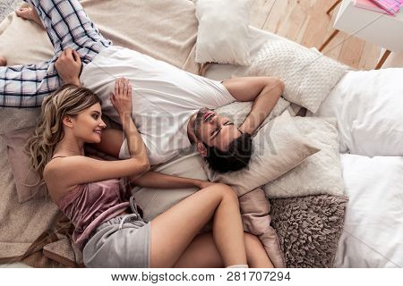 Dark-haired Handsome Young Man In A White T-shirt Looking Thoughtful