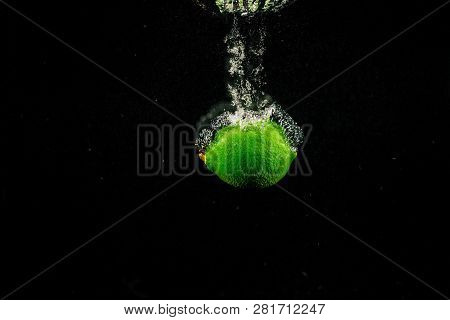 Sparkling Green Lime Splashes Water On Black Background
