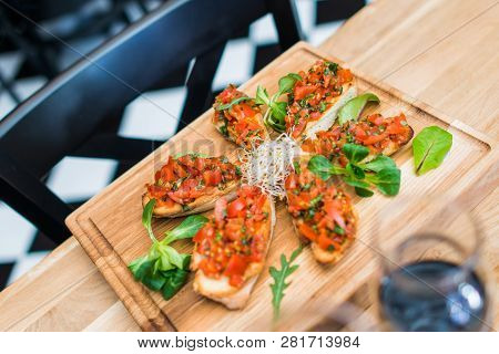 Tasty Italian Food Tomato Bruschetta Lunch On Wooden Board.