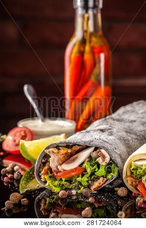 Two Burrito, Black And White Lavash With Chicken, Mushrooms, Salad, Cherry Tomatoes, Lime, And Salsa