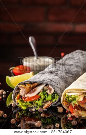 Two Burrito, Black And White Lavash With Chicken, Mushrooms, Salad, Cherry Tomatoes, Lime, And Salsa
