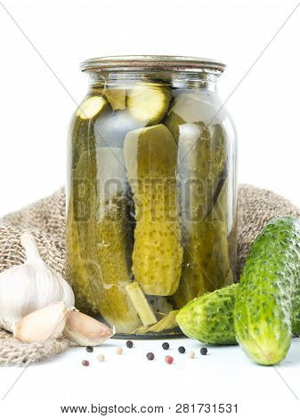 Pickled Cucumbers Isolated. Pickles In Glass Jar With Garlic And Peppercorn Isolated On White Backgr