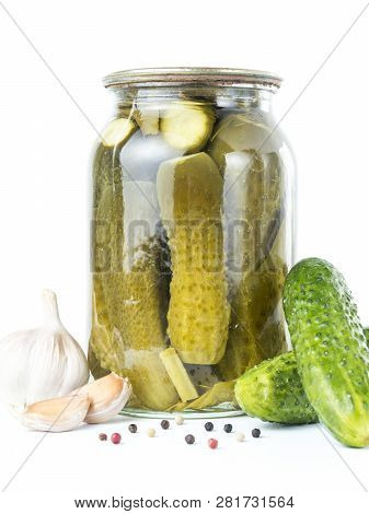 Pickled Cucumbers Isolated. Pickles In Glass Jar With Garlic And Peppercorn Isolated On White Backgr