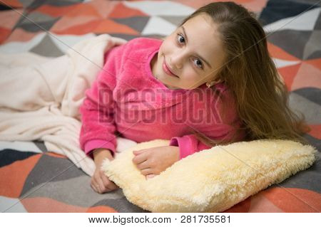 Playful Baby Relaxing. Pajamas And Bedroom Textile. Pajamas And Clothes For Home. Girl Little Kid We