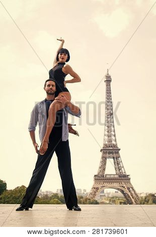 Dance Couple In Front Of Eifel Tower In Paris, France. Beatuiful Ballroom Dance Couple In Dance Pose