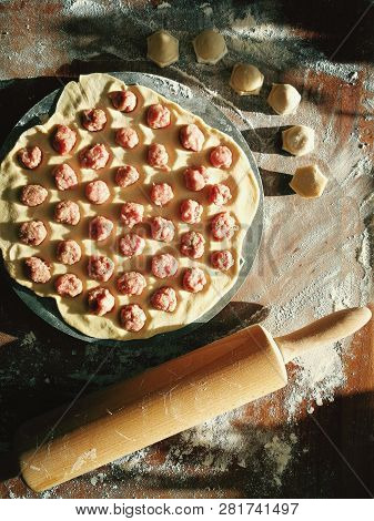 Uncooked Russian Pelmeni On Cutting Board And Ingredients For Homemade Pelmeni On White Table. Proce