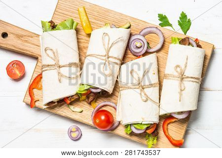 Burritos Tortilla Wraps With Beef And Vegetables On White Wooden Table.  Traditional Latin American 