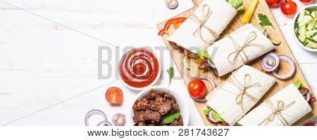 Burritos Tortilla Wraps With Beef And Vegetables On White Wooden Table.  Long Format.