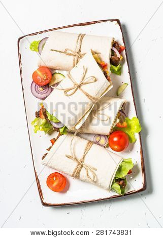 Burritos Tortilla Wraps With Beef And Vegetables On White Wooden Table.  Traditional Latin American 