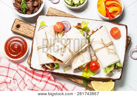 Burritos Tortilla Wraps With Beef And Vegetables On White Wooden Table.  Traditional Latin American 