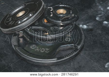 Bunch Of Heavy Black Barbell Weight Plates On The Gym Floor Prepared For Hard Core Fitness Workout S