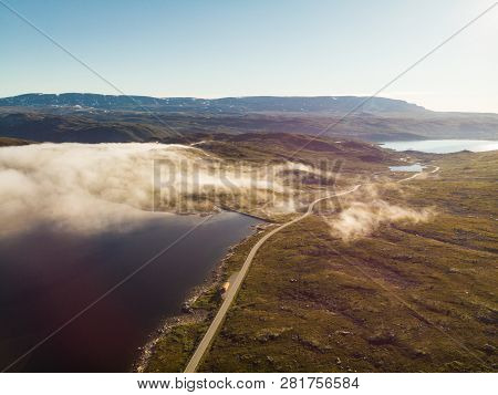 Aerial View. Road Crossing Hardangervidda Mountain Plateau, Clouds Over Lakes, Morning Time. Norway 
