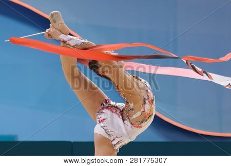 KIEV, UKRAINE - AUGUST 29, 2013: Lucille Chalopin, France performs with ribbon during 32nd Rhythmic Gymnastics World Championships. The event is held in Palace of Sport