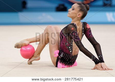 KIEV, UKRAINE - AUGUST 28, 2013: Lucille Chalopin, France performs with ball during 32nd Rhythmic Gymnastics World Championships. The event is held in Palace of Sport