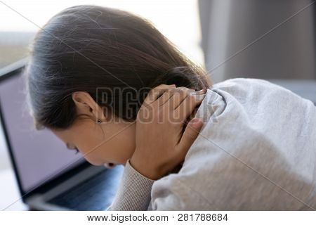 Close Up Rear View Of Tired Woman Rubbing Stiff Neck