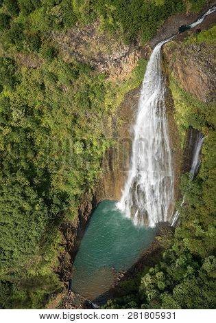 Aerial View Of Manawaiopuna Falls And Landscape Of Hawaiian Island Of Kauai From Helicopter Flight