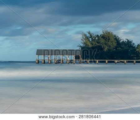 Sunrise Lights The Dawn Sky Above Hanalei Pier With Long Duration Exposure To Blur Waves Near Hanale