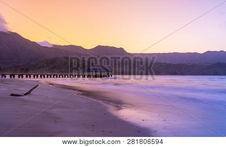 Sunrise Lights The Dawn Sky Above Hanalei Pier With The Na Pali Coast In The Background Near Hanalei