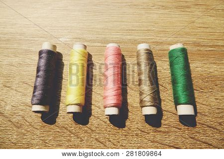 The Coils Of Threads Put On Wooden Table