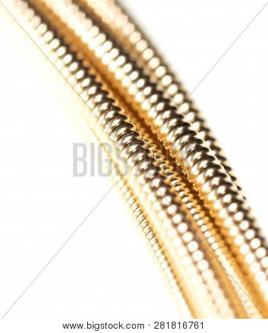Strings For Guitar Isolated On A White Background. Macro