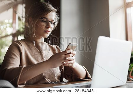 Picking Music To Boost Focus And Work. Portrait Of Charming European Gemale In Glasses With Trendy H