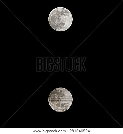 Full Moon With Reflection On Black Water At Midnight And Black Sky