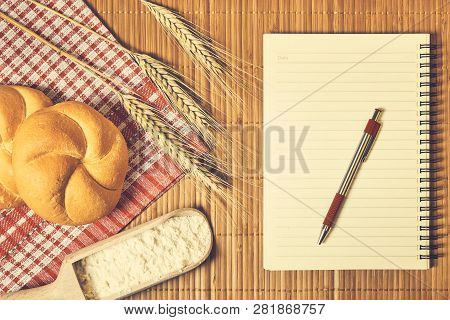 Bakery Food And Notebook On The Table