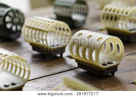 Necessary Accessories For Feeder Fishing On A Wooden Board. Feeder Feeders Side View.