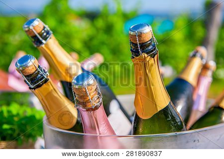 Bottles Of Champagne, Sparkling Wine In Cooler At Wedding Reception Outdoors, Wedding And Summer Par