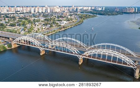 Aerial Top View Of Automobile And Railroad Darnitsky Bridge Across Dnieper River From Above, Kiev (k