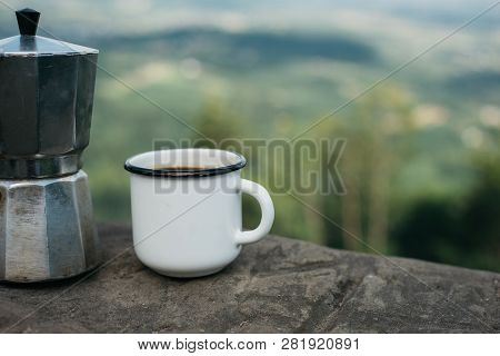 Cup Hot Coffee And Coffee Maker On Background Of Nature. Concept Adventure Active Vacations Outdoor.