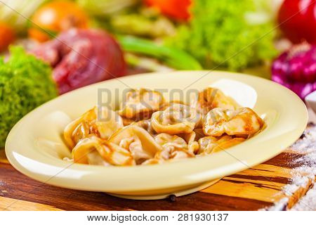 Dumplings With Meat In Beige Plate On Wooden Board. Russian Cuisine