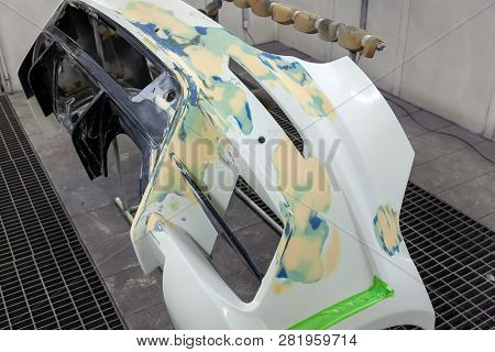 Repair Of The Rear Bumper Of A White Car After An Accident With The Help Of Multi-colored Putty In A
