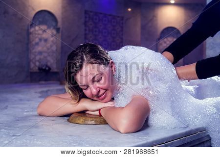 Young Woman In Red Bikini Relaxing In Hammam Or Turkish Bath.