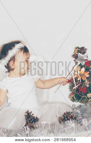 Little Child In The Costume Of An Angel. Selective Focus.