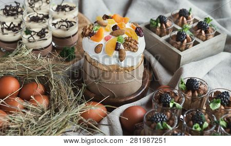 Easter Composition Of Sweet Cake With Dried Fruits And Nuts, And Various Desserts On Light Backgroun