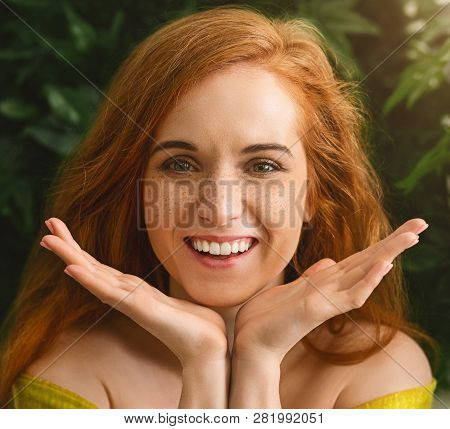 Cheerful Foxy Girl Enjoying Her Freckles, Holding Face In Palms, Smiling At Camera